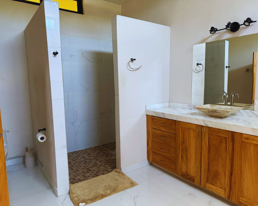 Detalle de baños completos limpios equipados con agua caliente en regaderas