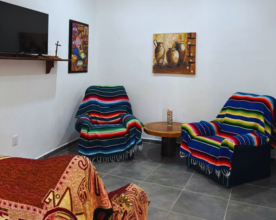 Sala de estar con sofá cama, sillones y televisión